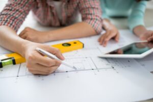 homeowners studying a detailed renovation plan