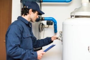 plumber inspecting a water heater of a beautiful home kitchen