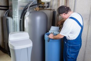 professional plumber installing water softener